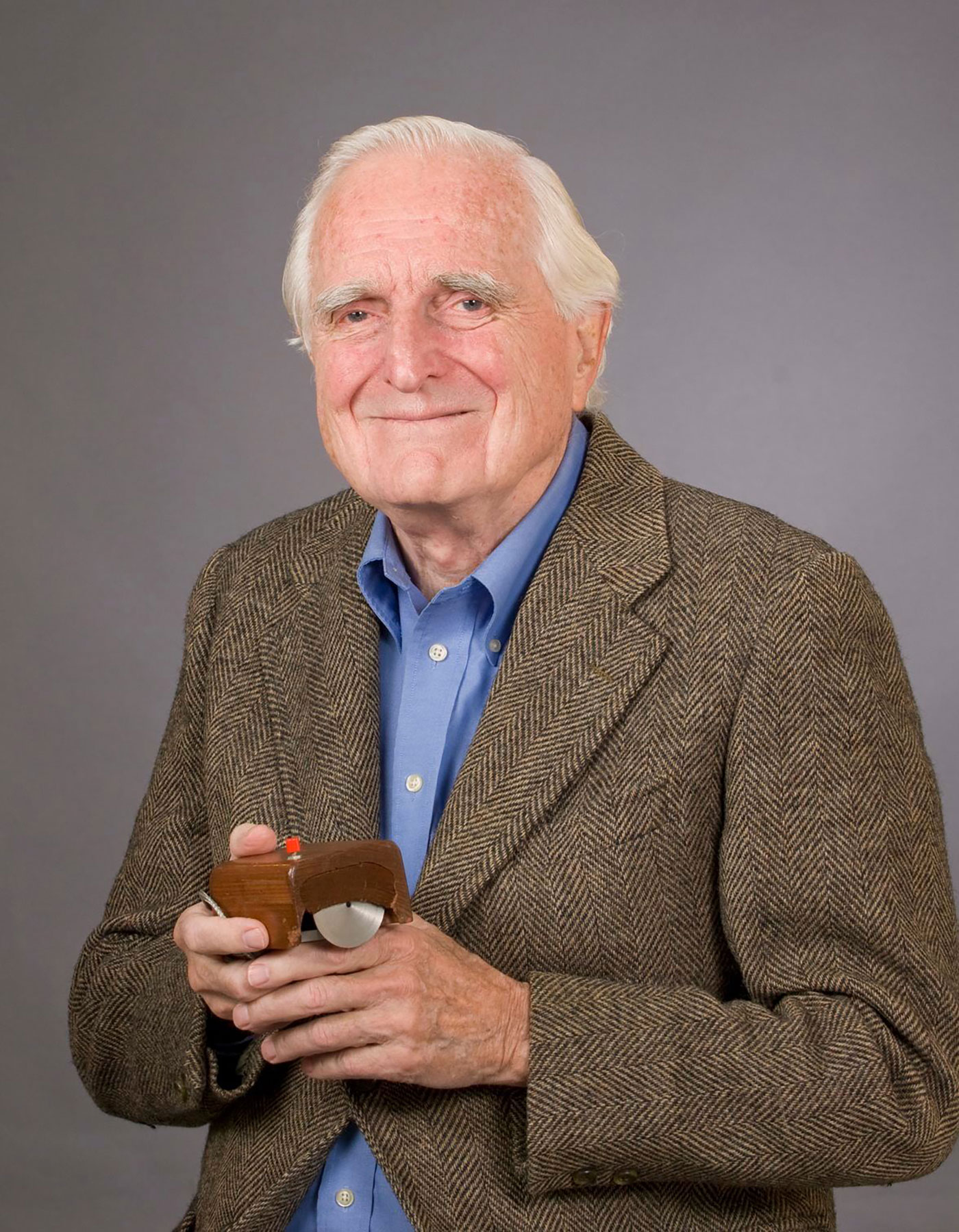 Founder of Augmented Research Center at SRI holding the first mouse which he developed alongside ethernet and a rudimentary form of gooey.